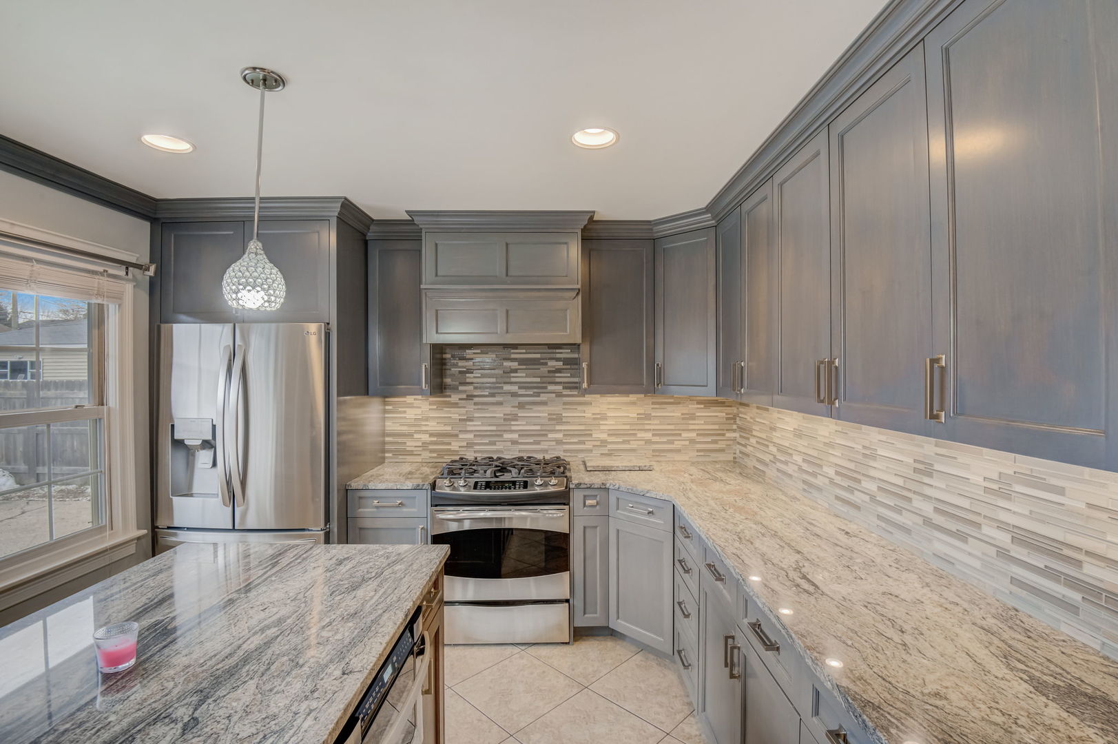 1673 East Algonquin Road Des Plaines, IL 60016 - Photo 10 of 36 a kitchen with stainless steel appliances granite countertop a stove a sink and a refrigerator