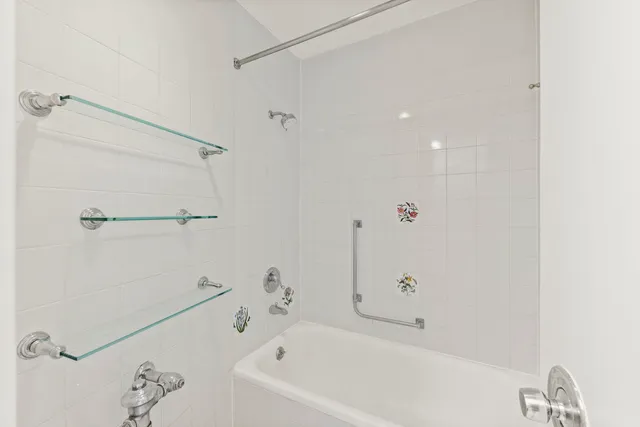 a bathroom with a bathtub and a shower