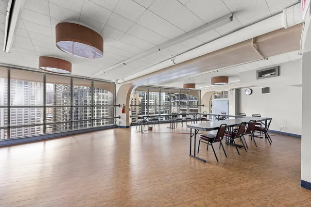 a view of a dining room with furniture wooden floor and chandelier