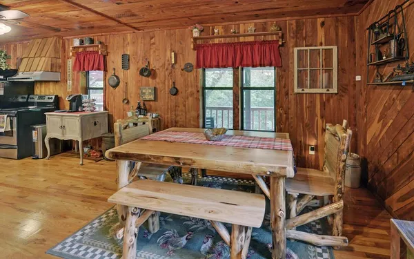 a dining room with a bed and a window