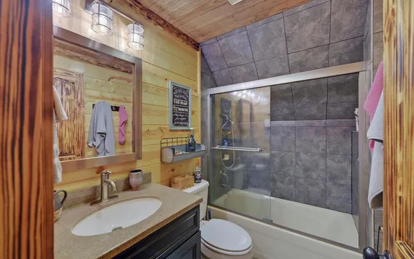 a bedroom with a bed and flat screen tv