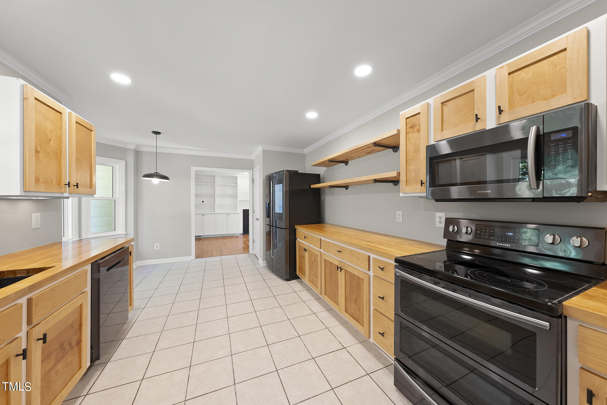 6709 Holly Mill Court Raleigh, NC 27613 - Photo 11 of 36 a kitchen with stainless steel appliances a stove a sink and a microwave