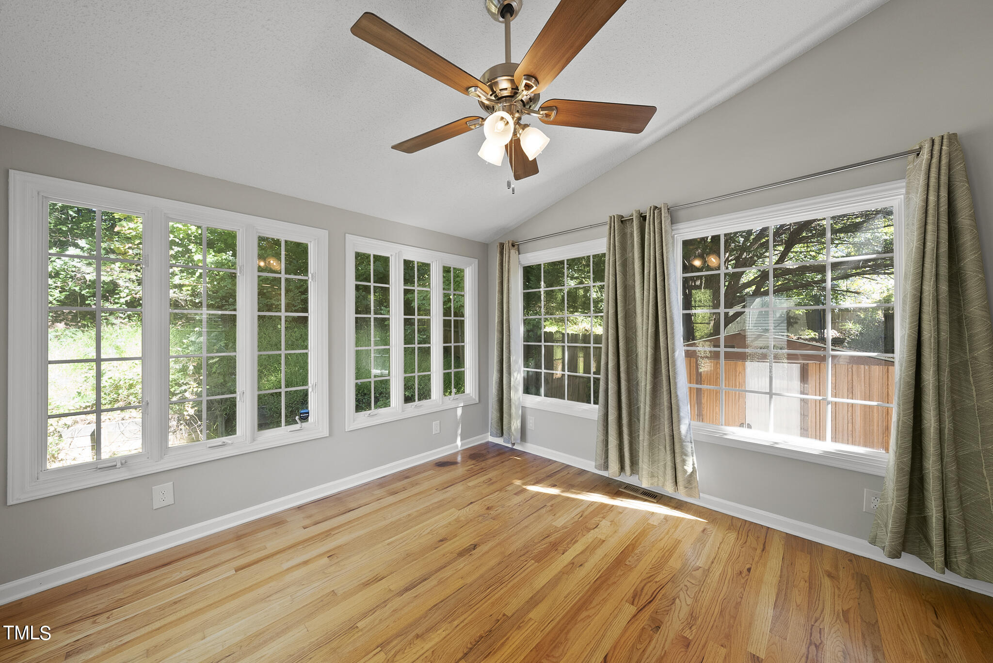 6709 Holly Mill Court Raleigh, NC 27613 - Photo 12 of 36 a view of an empty room with wooden floor and a window