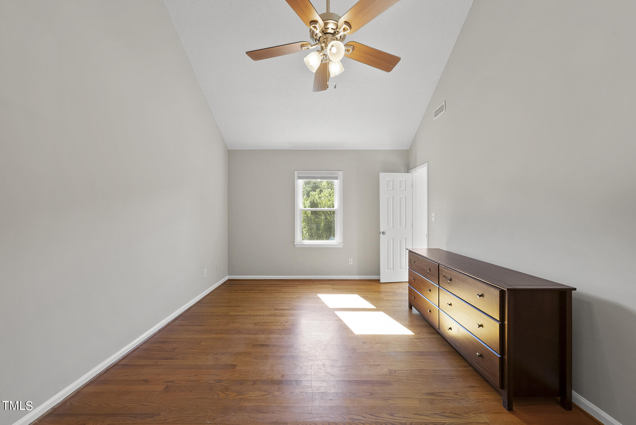 6709 Holly Mill Court Raleigh, NC 27613 - Photo 20 of 36 wooden floor in an empty room with a window