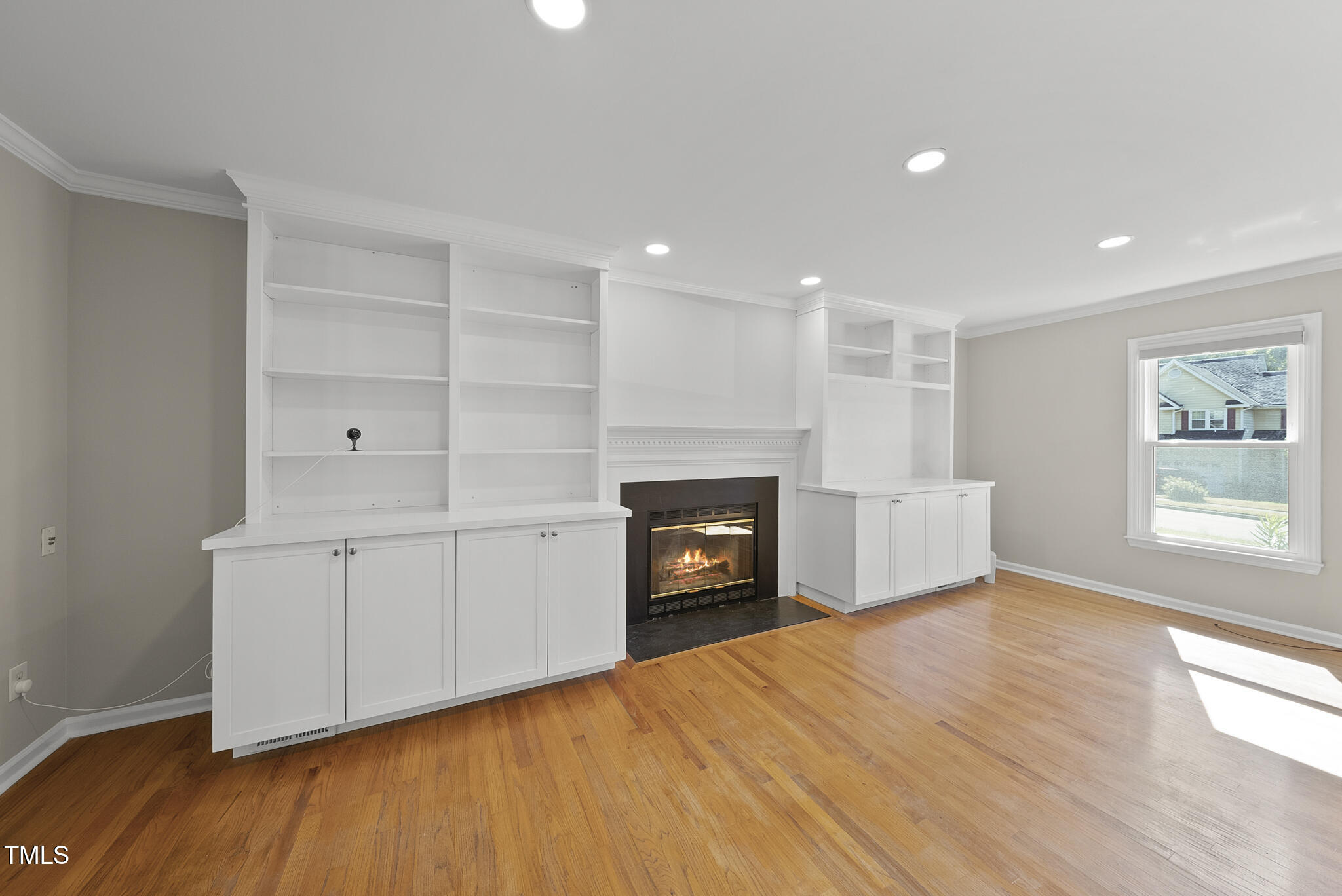 6709 Holly Mill Court Raleigh, NC 27613 - Photo 2 of 36 a view of empty room with a fireplace and wooden floor
