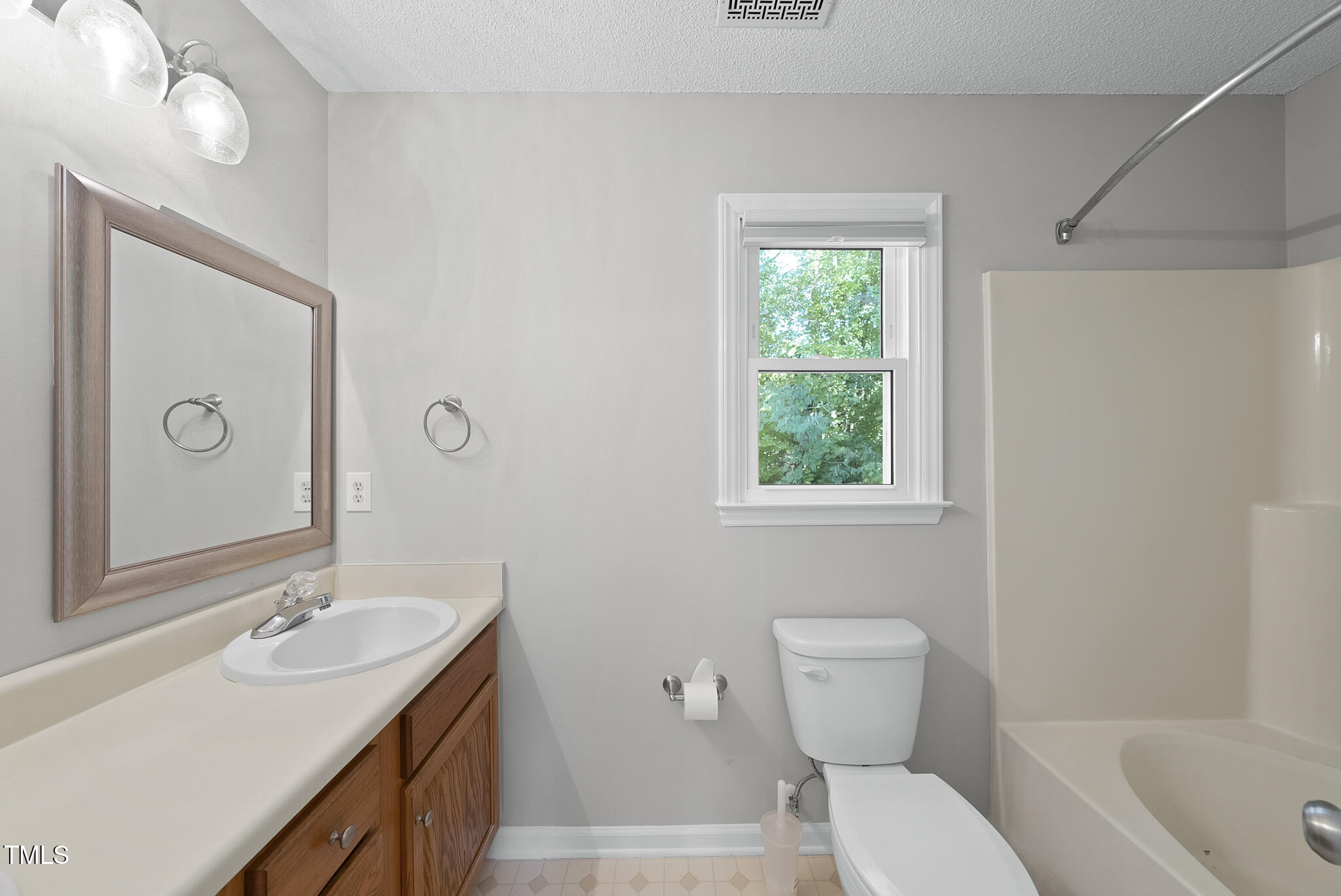 6709 Holly Mill Court Raleigh, NC 27613 - Photo 22 of 36 a bathroom with a toilet a sink a tub and mirror