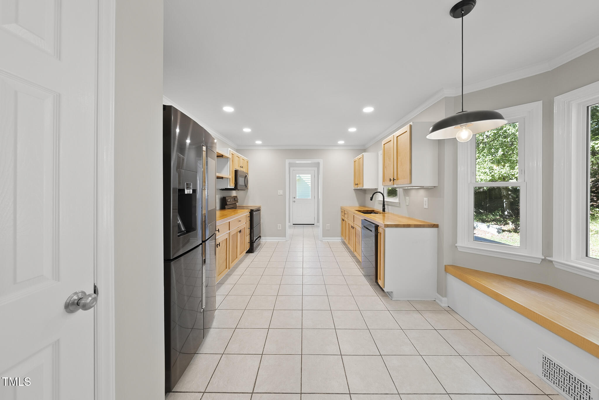 6709 Holly Mill Court Raleigh, NC 27613 - Photo 5 of 36 a kitchen with stainless steel appliances granite countertop a refrigerator and a stove top oven
