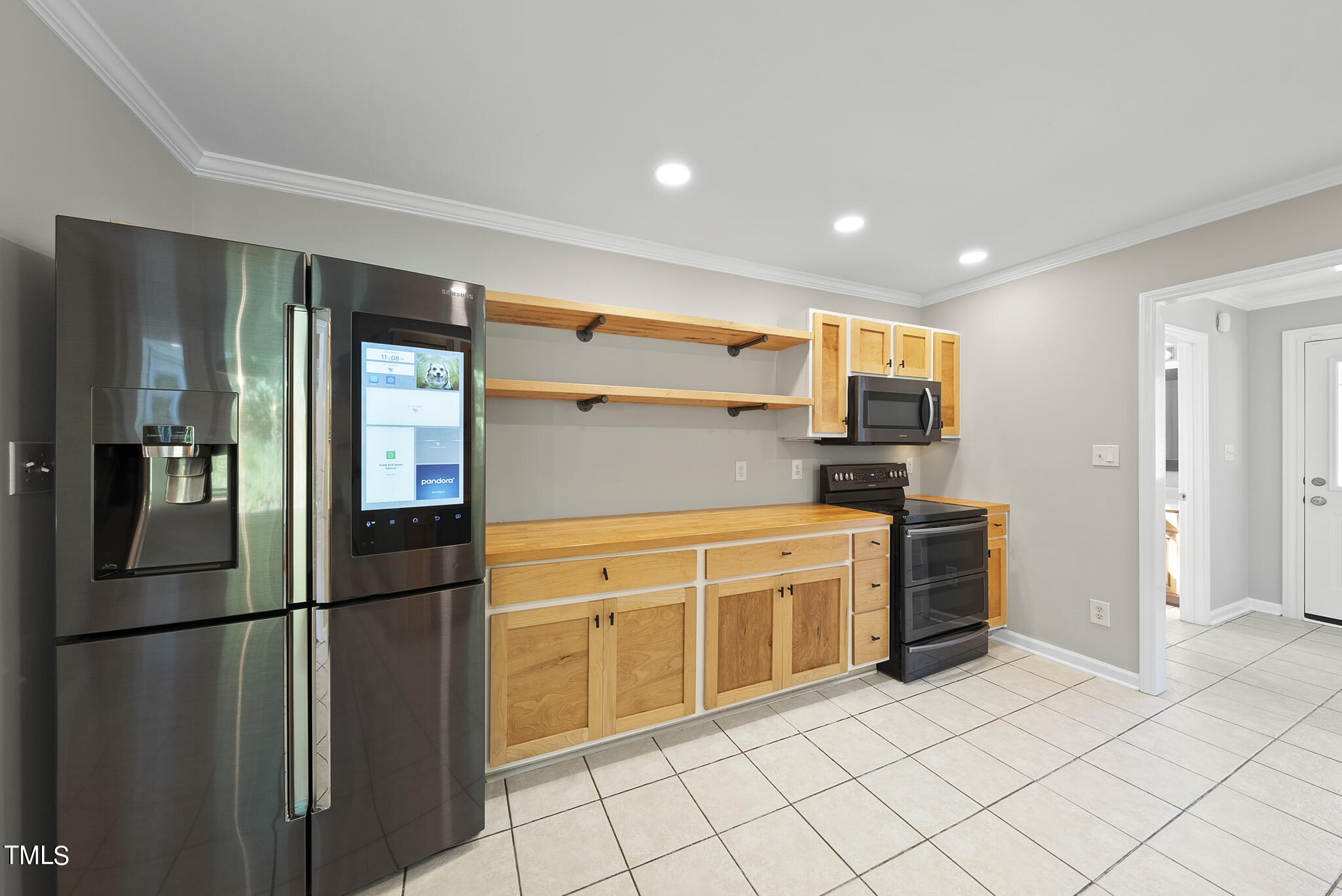 6709 Holly Mill Court Raleigh, NC 27613 - Photo 10 of 36 a kitchen with granite countertop a refrigerator and a sink