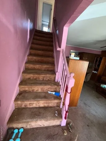 a view of an empty room and wooden floor