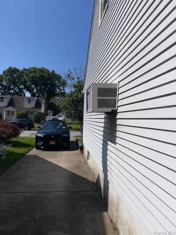 a view of house with backyard and trees