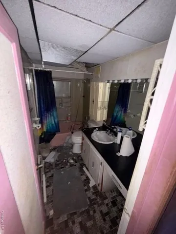 a bathroom with a double vanity sink and a mirror