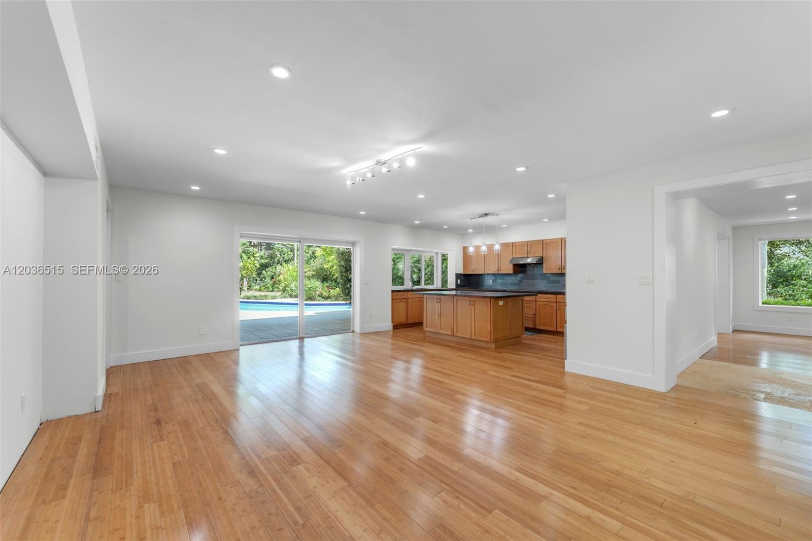 7711 Erwin Road Coral Gables, FL 33143 - Photo 11 of 26 a view of a living room a kitchen with wooden floor and a kitchen