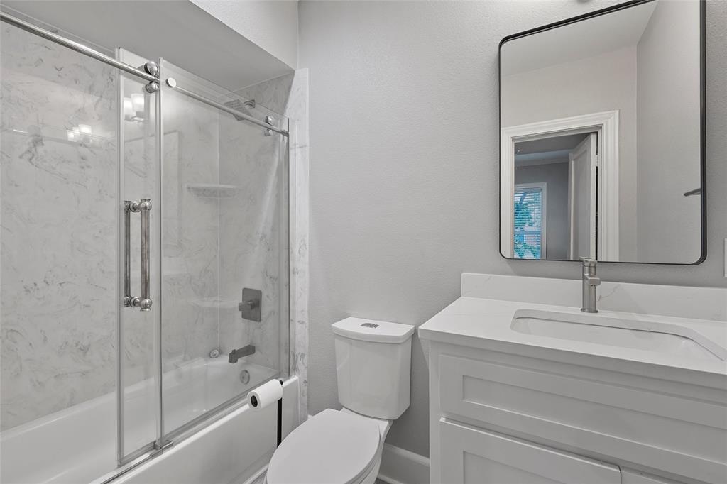 1500 South 10th Street Waco, TX 76706 - Photo 16 of 25 Bathroom with enclosed tub / shower combo, vanity, and a textured wall