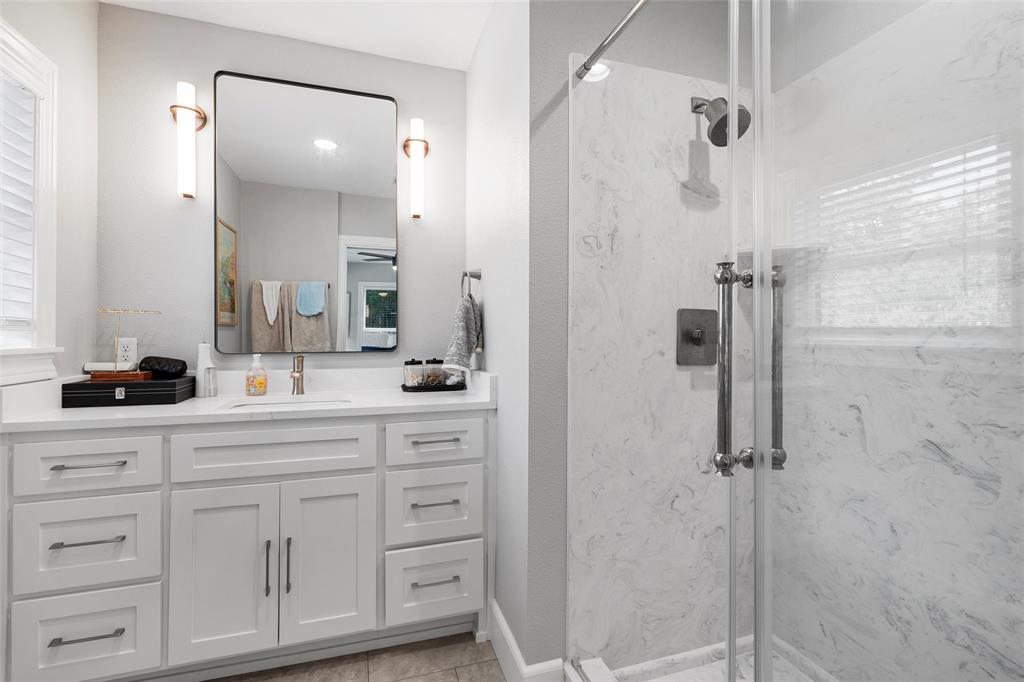 1500 South 10th Street Waco, TX 76706 - Photo 18 of 25 Bathroom featuring a marble finish shower, vanity, and light tile patterned floors