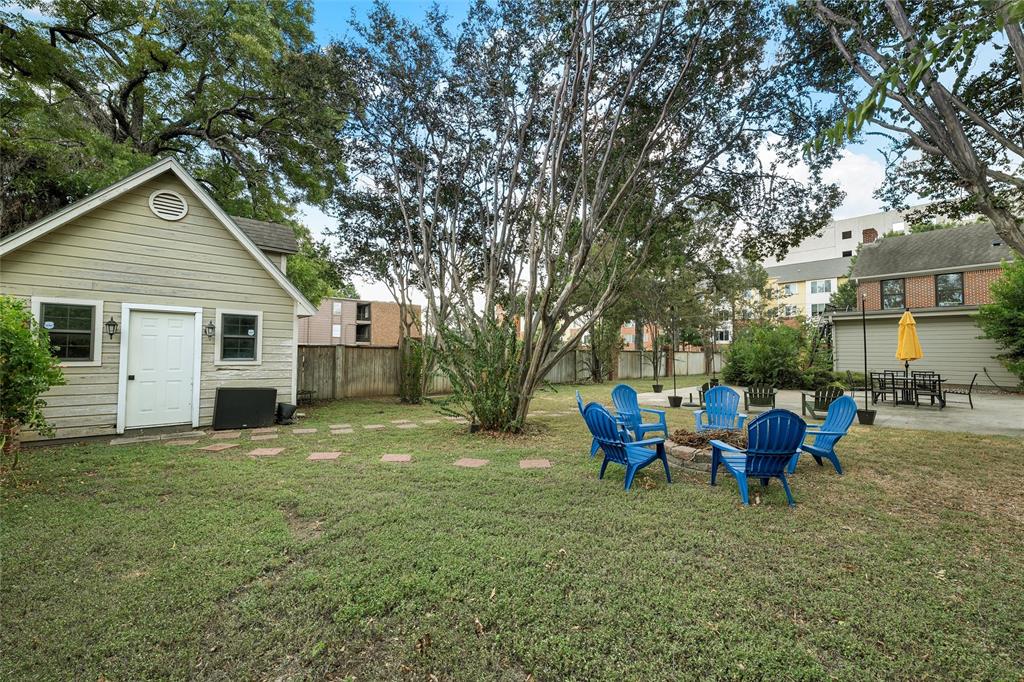 1500 South 10th Street Waco, TX 76706 - Photo 21 of 25 Fenced backyard with an outdoor fire pit and a patio