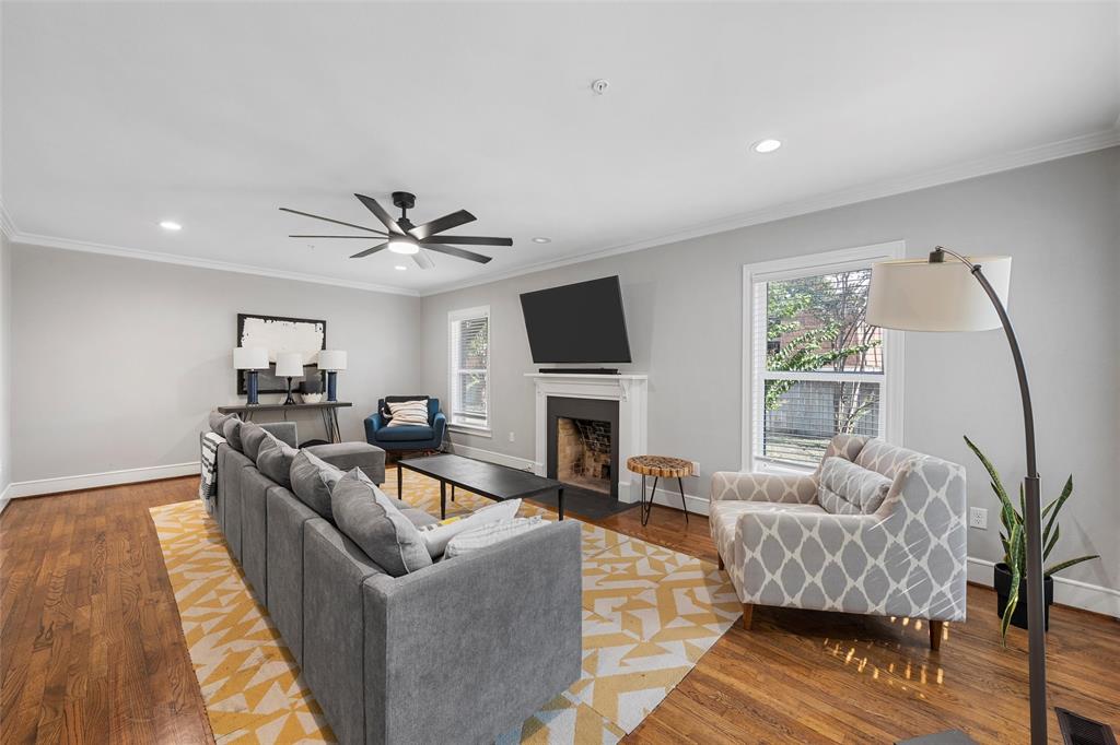 1500 South 10th Street Waco, TX 76706 - Photo 3 of 25 Living area with crown molding, plenty of natural light, a fireplace with flush hearth, wood finished floors, and recessed lighting