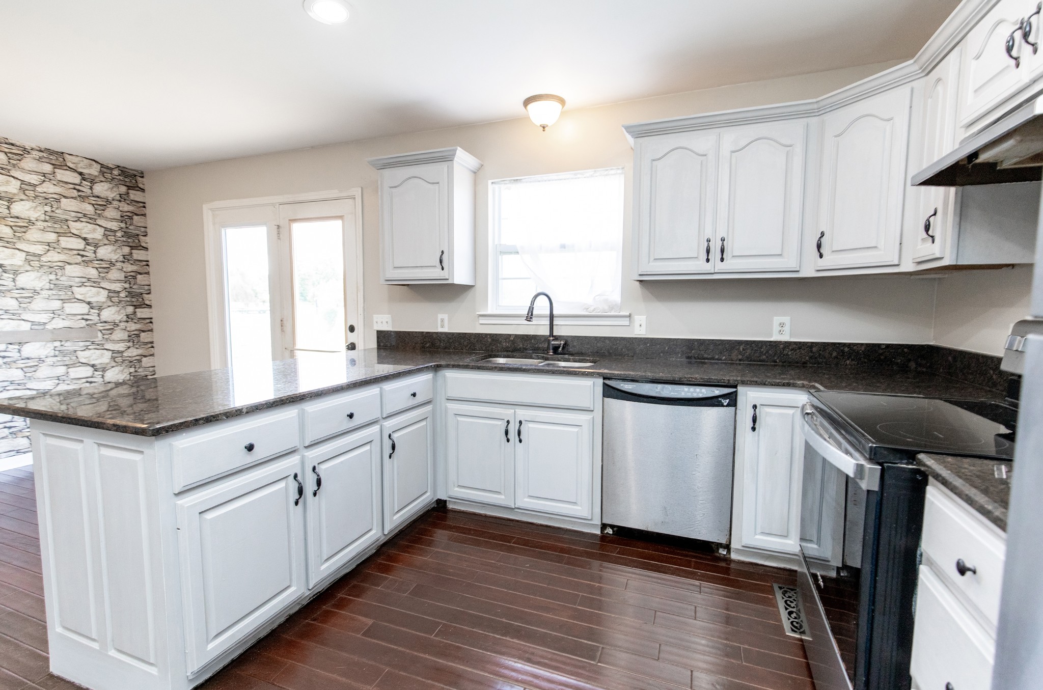 443 Clearview Road Cottontown, TN 37048 - Photo 2 of 21 a kitchen with granite countertop white cabinets and white appliances