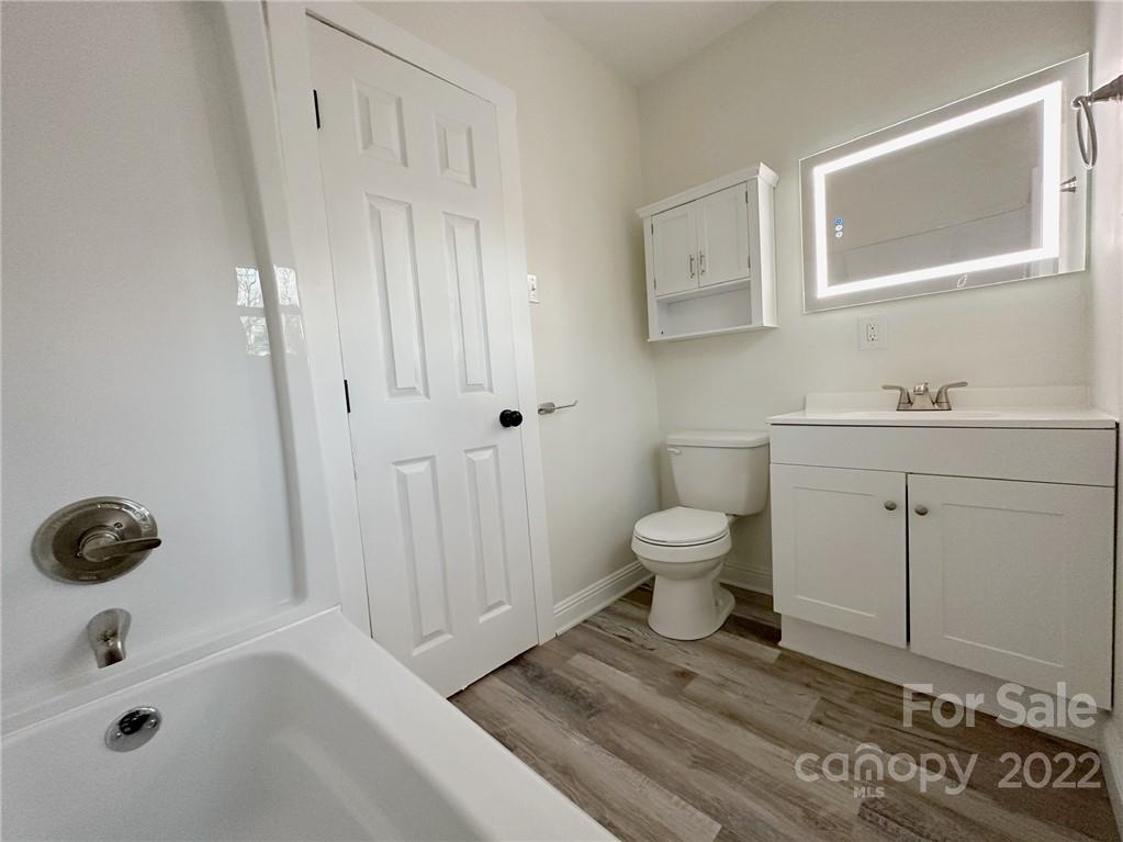 506 East Frederick Street Gaffney, SC 29340 - Photo 11 of 25 a bathroom with a toilet a sink and mirror