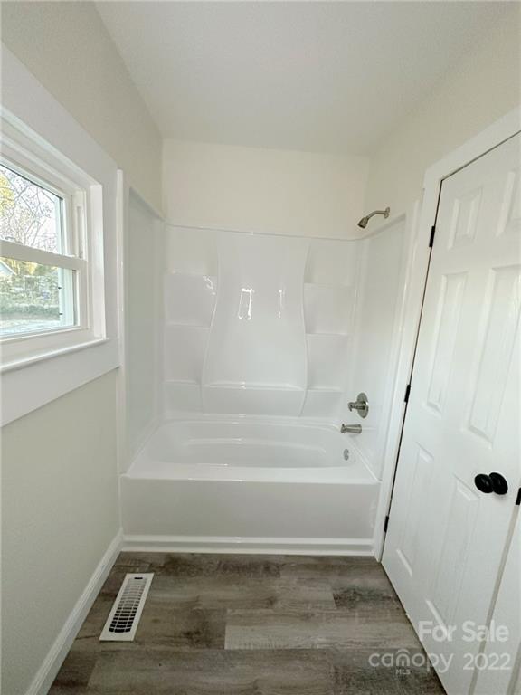 506 East Frederick Street Gaffney, SC 29340 - Photo 12 of 25 a bathroom with a tub and window