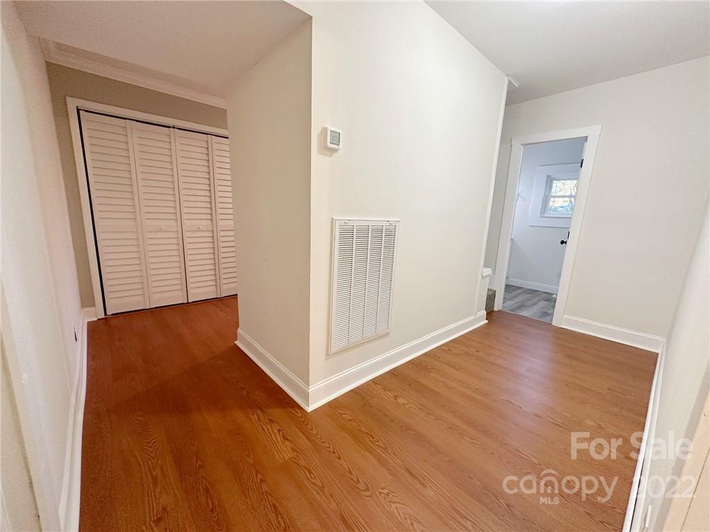 506 East Frederick Street Gaffney, SC 29340 - Photo 13 of 25 an empty room with wooden floor and windows
