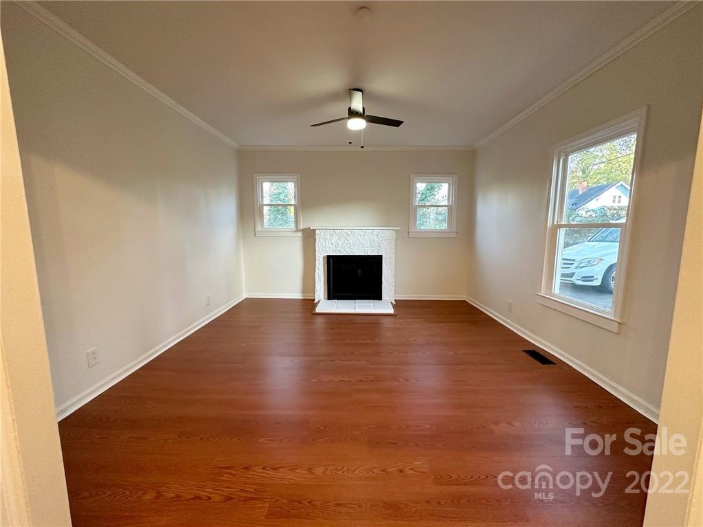 506 East Frederick Street Gaffney, SC 29340 - Photo 7 of 25 an empty room with windows and fireplace
