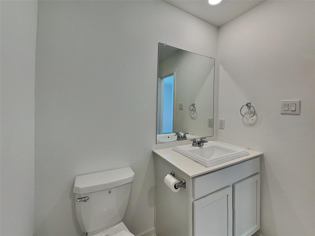 4229 Brindley Road Little Elm, TX 75068 - Photo 13 of 15 a bathroom with a sink toilet and mirror