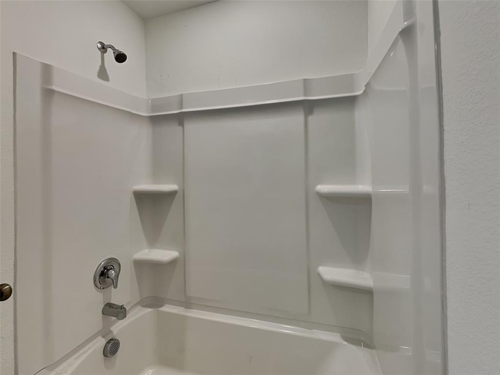 4229 Brindley Road Little Elm, TX 75068 - Photo 14 of 15 a bathroom with a shower and bathtub