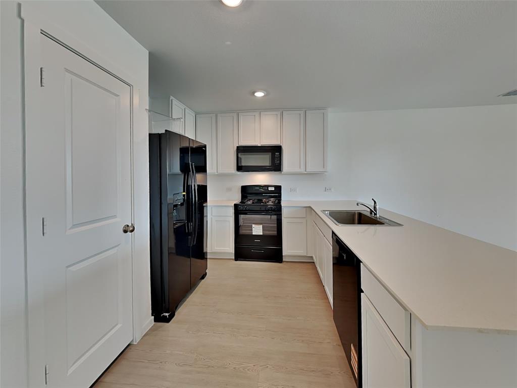 4229 Brindley Road Little Elm, TX 75068 - Photo 3 of 15 a kitchen with a refrigerator a sink and a stove top oven