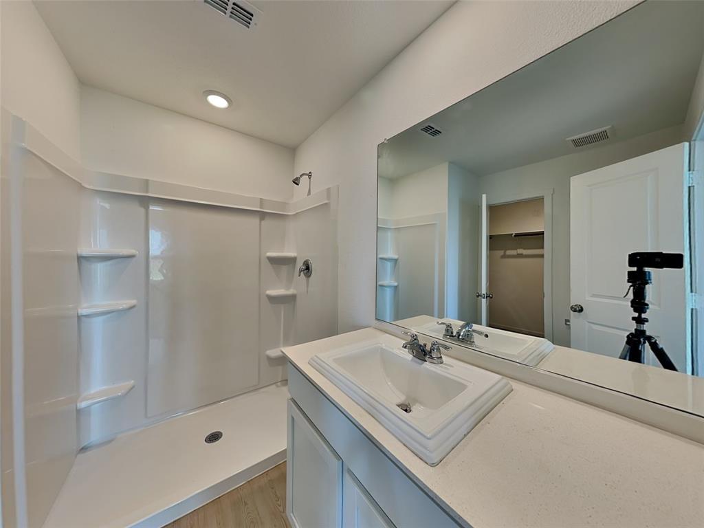 4229 Brindley Road Little Elm, TX 75068 - Photo 7 of 15 a bathroom with a sink and a mirror