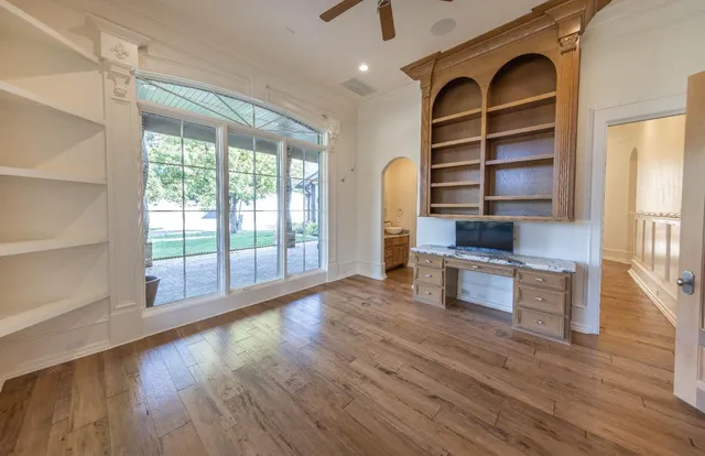 a living room with stainless steel appliances wooden floor and a window