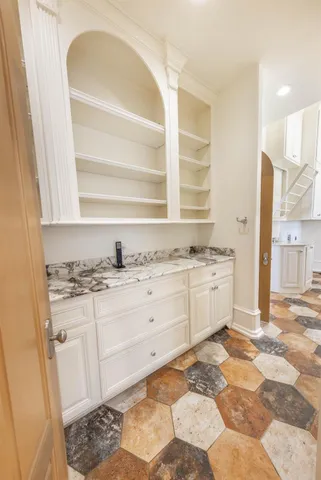 a view of kitchen with granite countertop cabinets appliances and a window