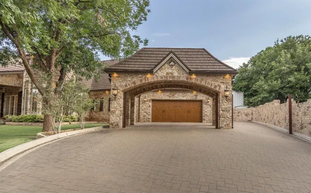 a view of a house with a yard and garage