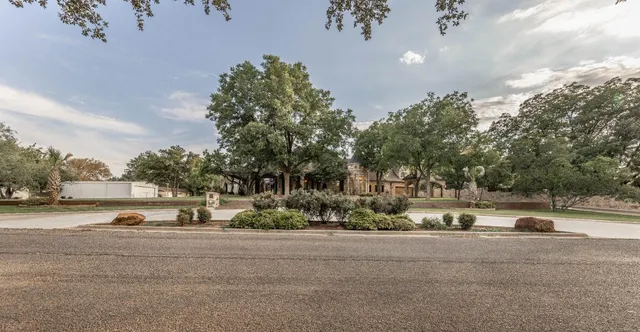 a view of street with houses and trees in the background