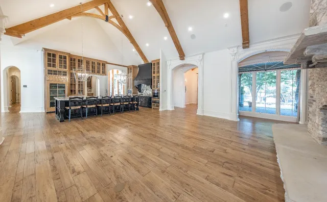 a hallway with wooden floor and furniture