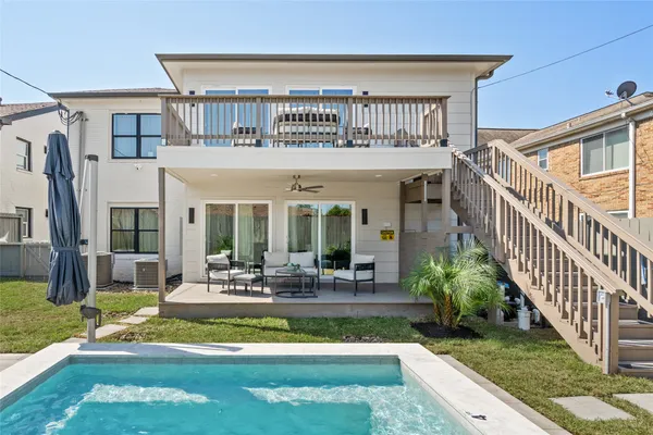 a view of a house with backyard porch and sitting area