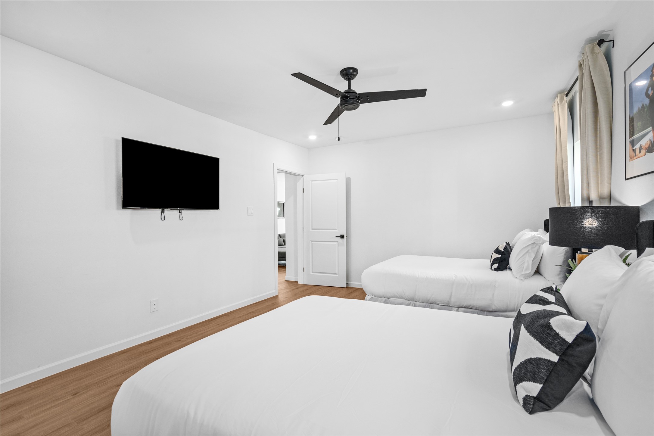 2901 Cleburne Street Houston, TX 77004 - Photo 19 of 50 a bedroom with a bed and a flat screen tv