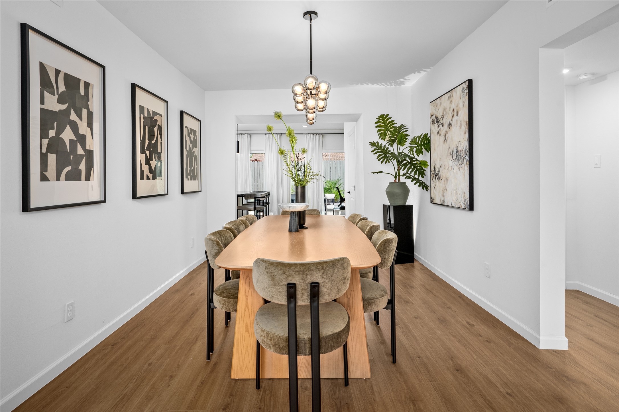 2901 Cleburne Street Houston, TX 77004 - Photo 9 of 50 a dining room with furniture potted plants and wooden floor