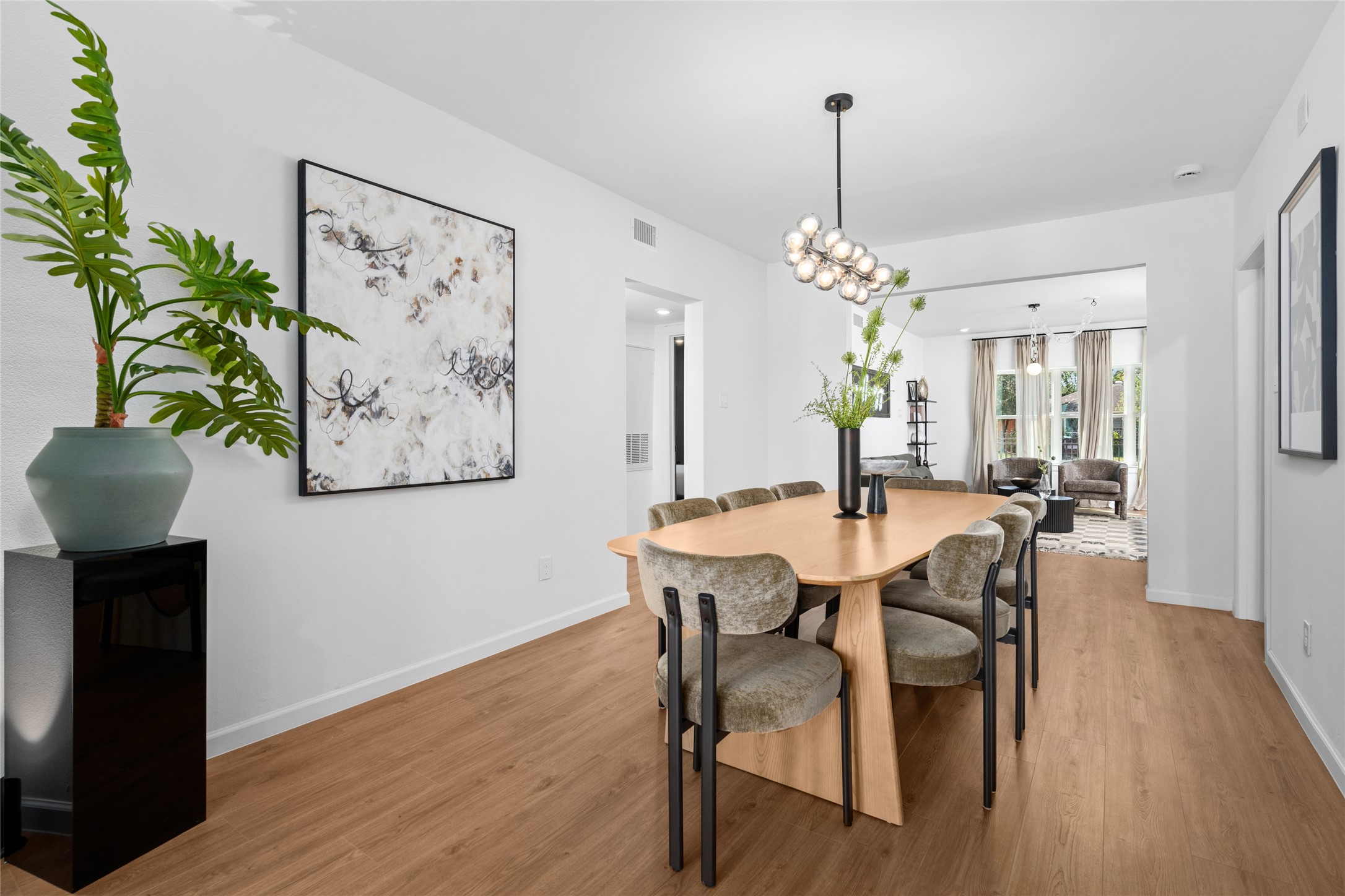 2901 Cleburne Street Houston, TX 77004 - Photo 10 of 50 a dining room with furniture potted plants and wooden floor