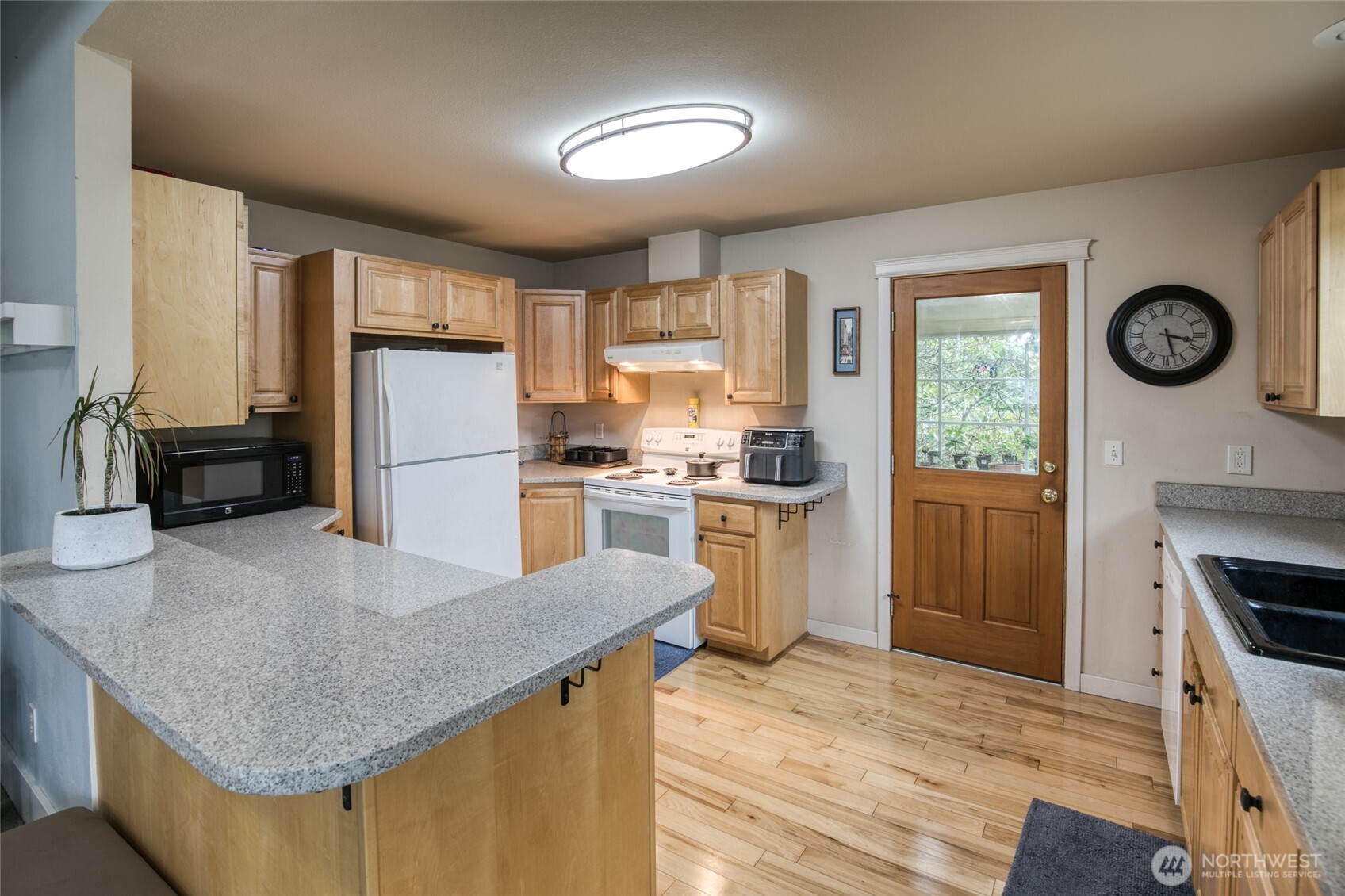 722 7th Avenue Aberdeen, WA 98520 - Photo 13 of 38 a kitchen with refrigerator cabinets and wooden floor