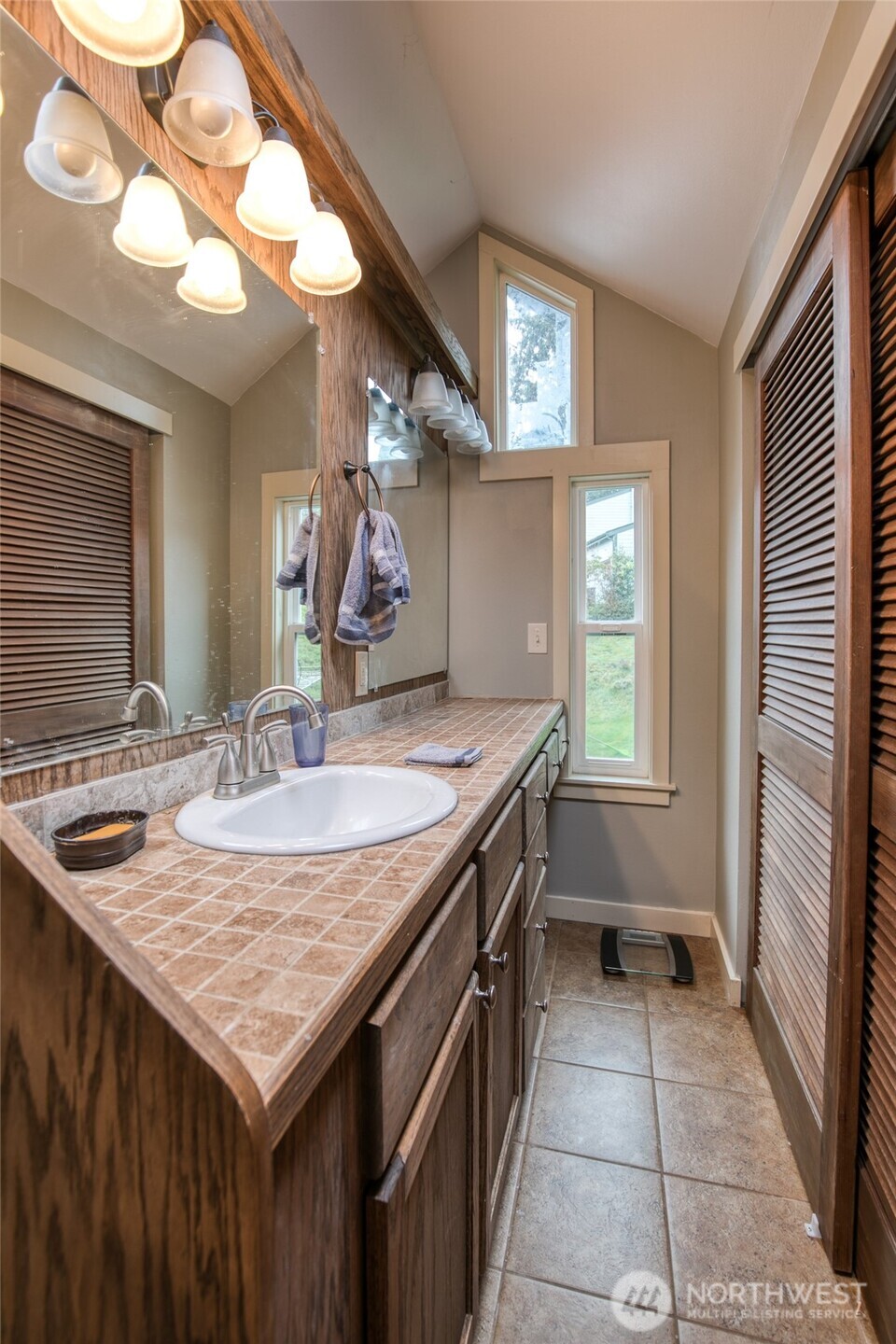 722 7th Avenue Aberdeen, WA 98520 - Photo 25 of 38 a kitchen with a stove a sink and a wooden cabinets
