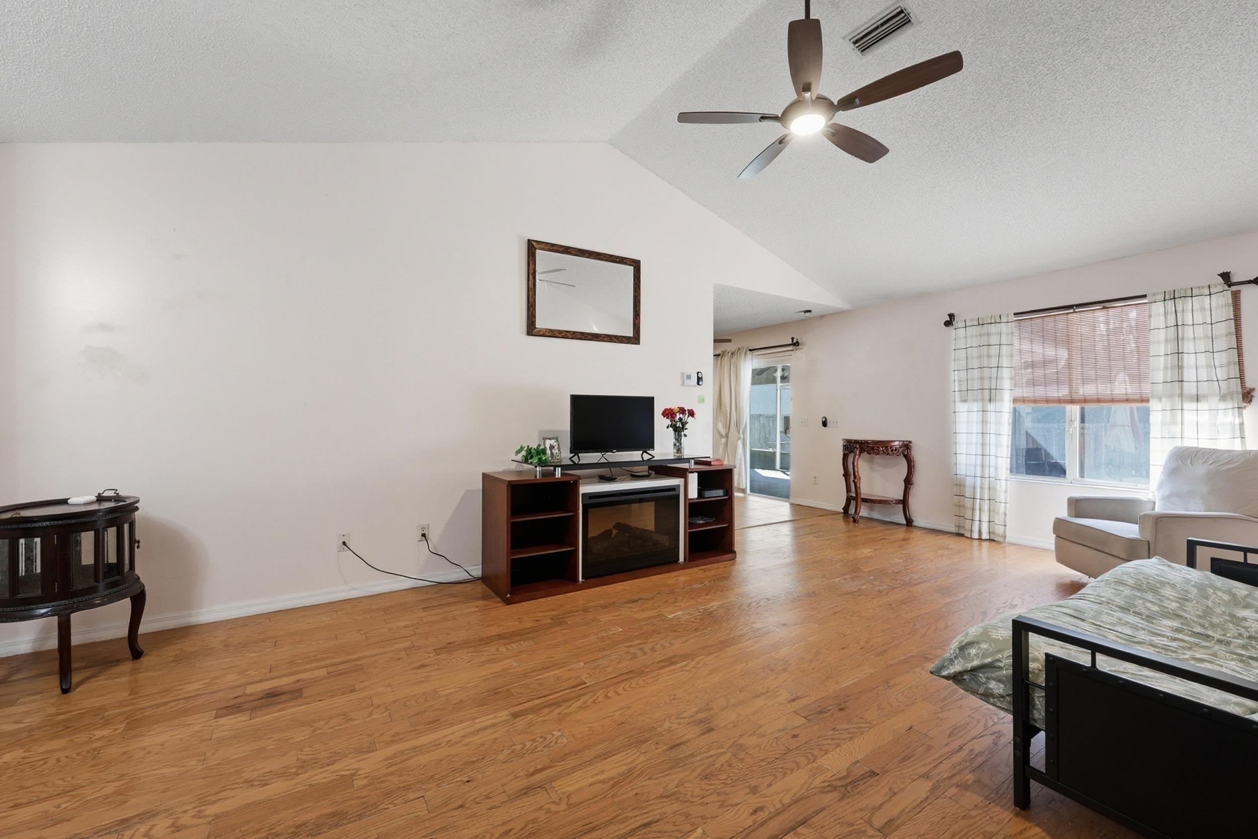 5296 Timucua Circle St. Augustine, FL 32086 - Photo 11 of 65 Living room featuring a textured ceiling, light wood finished floors, and ceiling fan