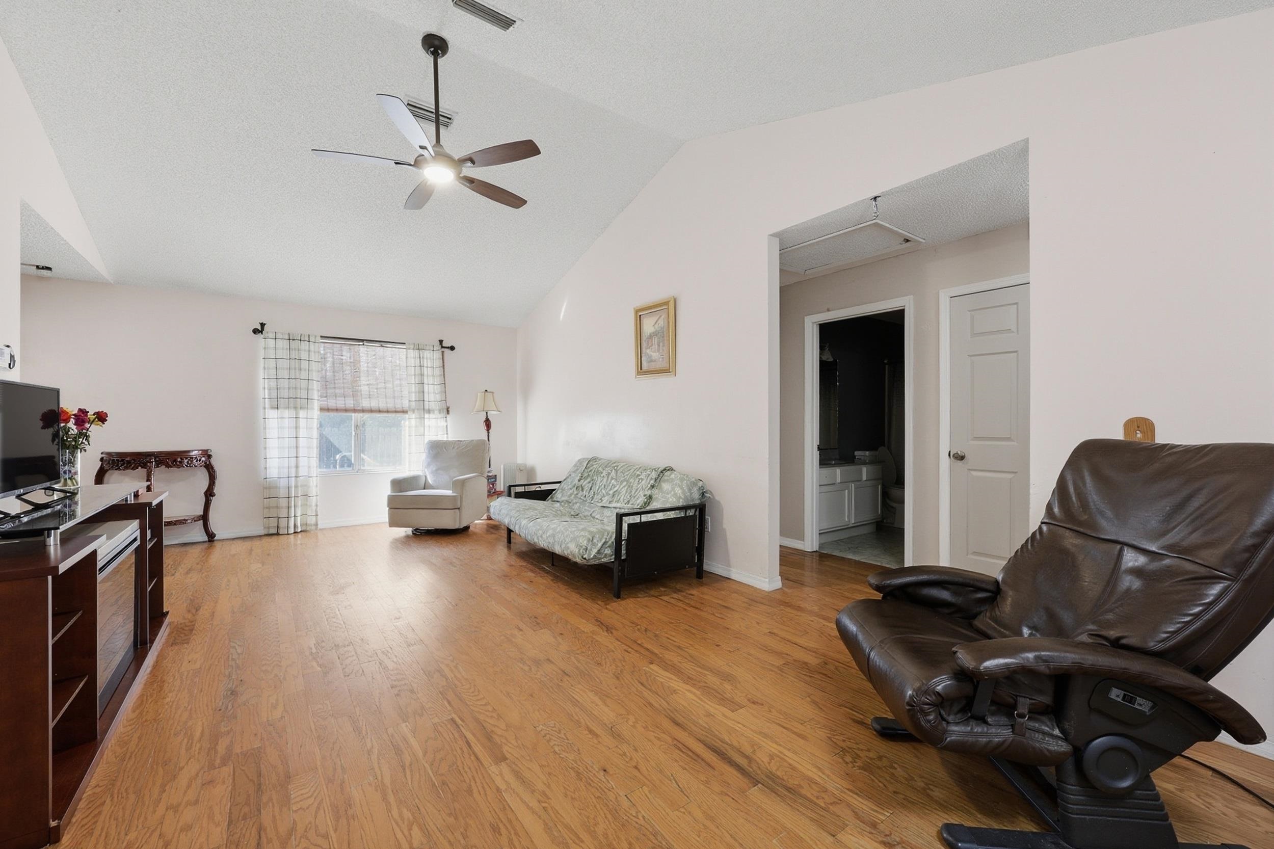 5296 Timucua Circle St. Augustine, FL 32086 - Photo 12 of 65 Sitting room featuring vaulted ceiling, ceiling fan, and light wood-style floors