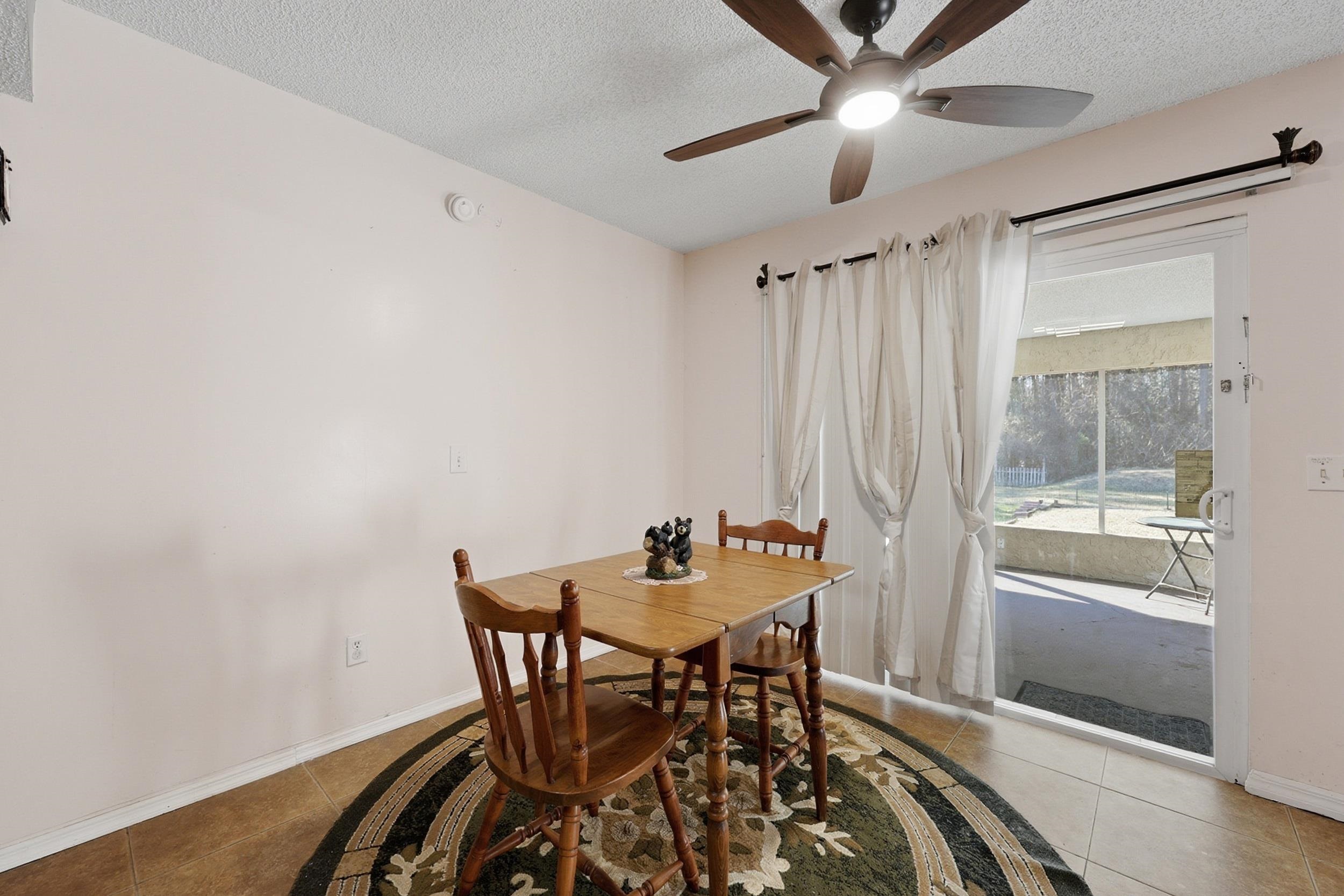 5296 Timucua Circle St. Augustine, FL 32086 - Photo 17 of 65 Dining space with light tile patterned floors, a textured ceiling, and ceiling fan