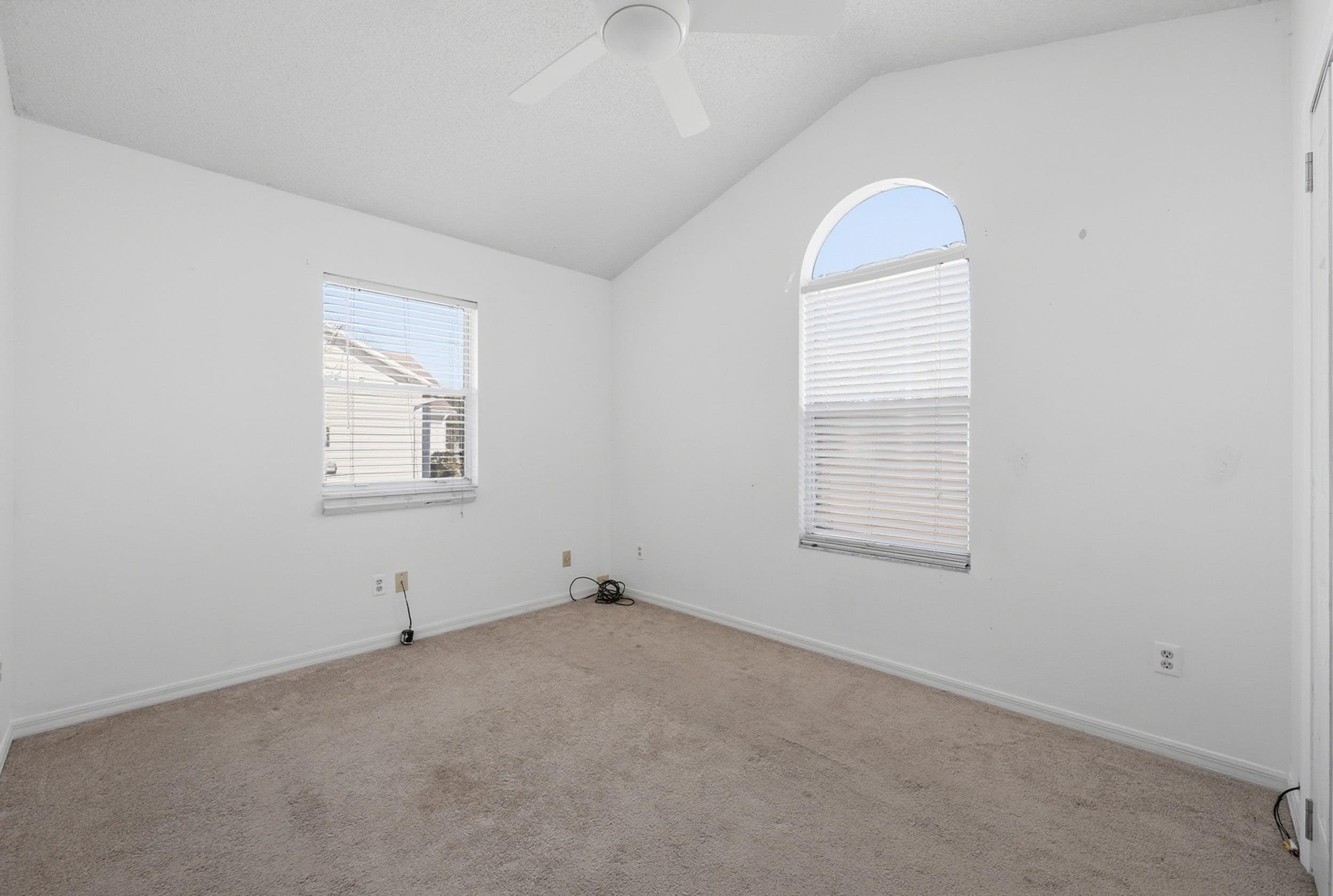 5296 Timucua Circle St. Augustine, FL 32086 - Photo 19 of 65 Unfurnished room featuring healthy amount of natural light, lofted ceiling, light colored carpet, and ceiling fan