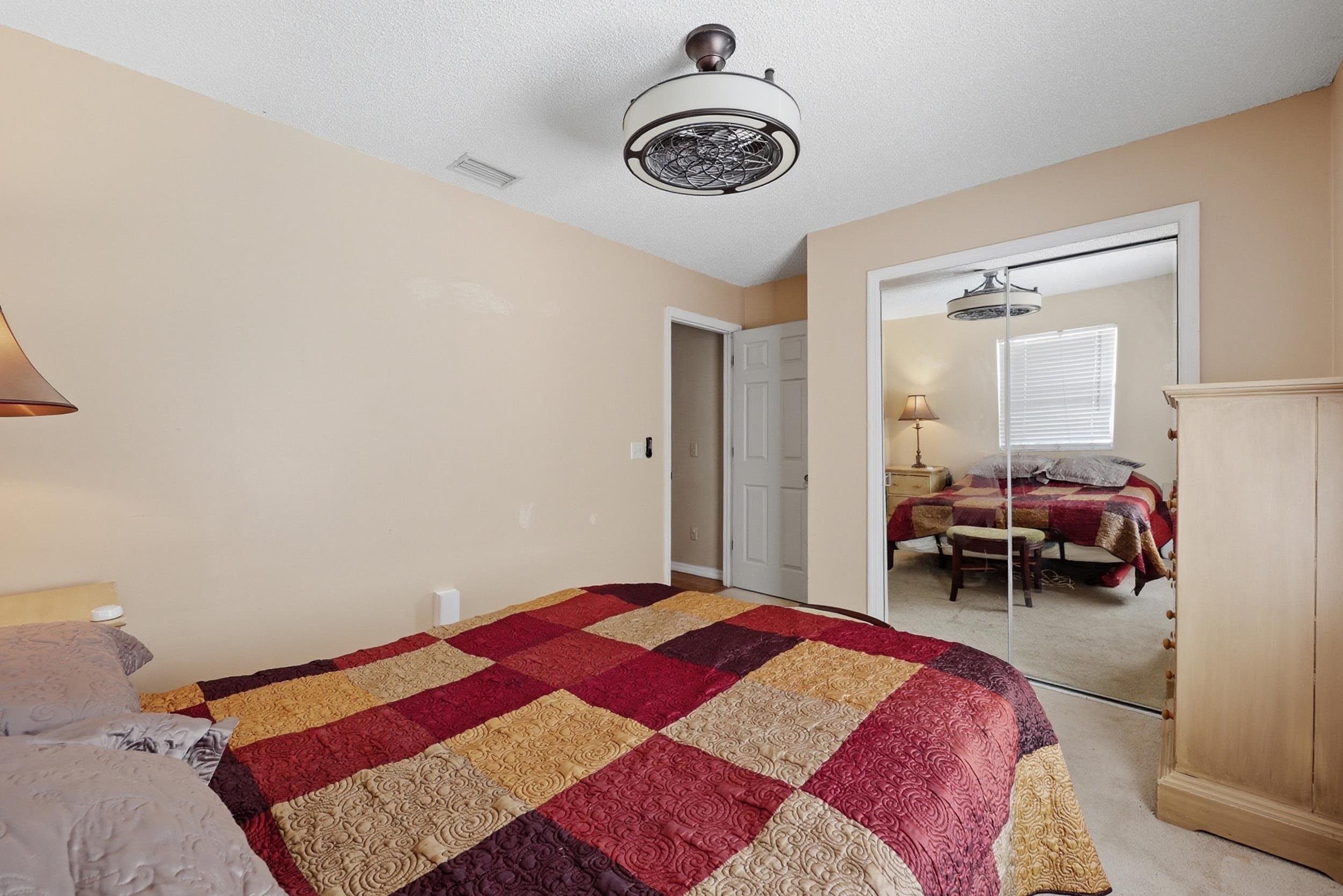 5296 Timucua Circle St. Augustine, FL 32086 - Photo 23 of 65 Carpeted bedroom featuring a ceiling fan and a closet