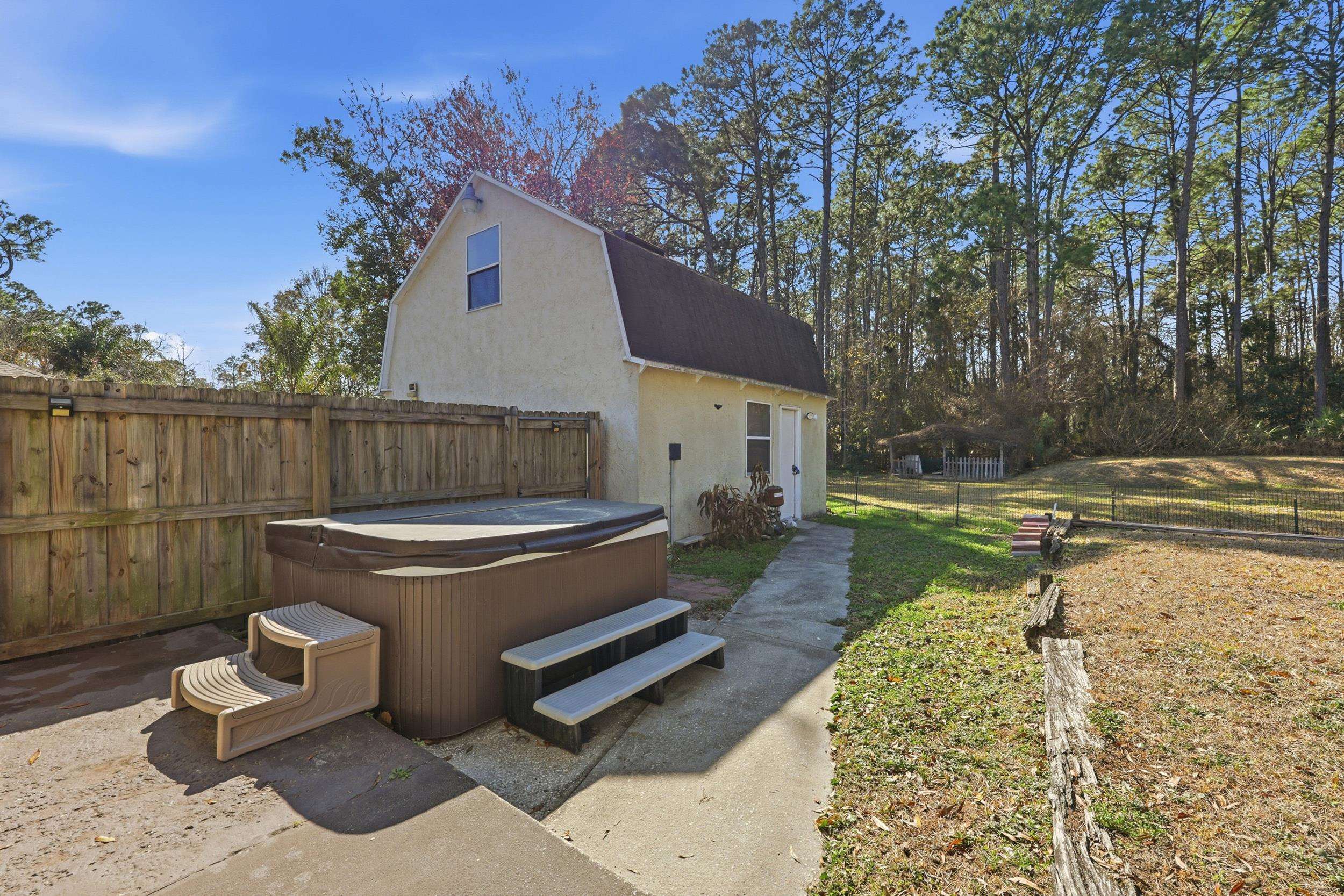 5296 Timucua Circle St. Augustine, FL 32086 - Photo 42 of 65 Exterior space featuring a fenced backyard, stucco siding, a hot tub, and a patio