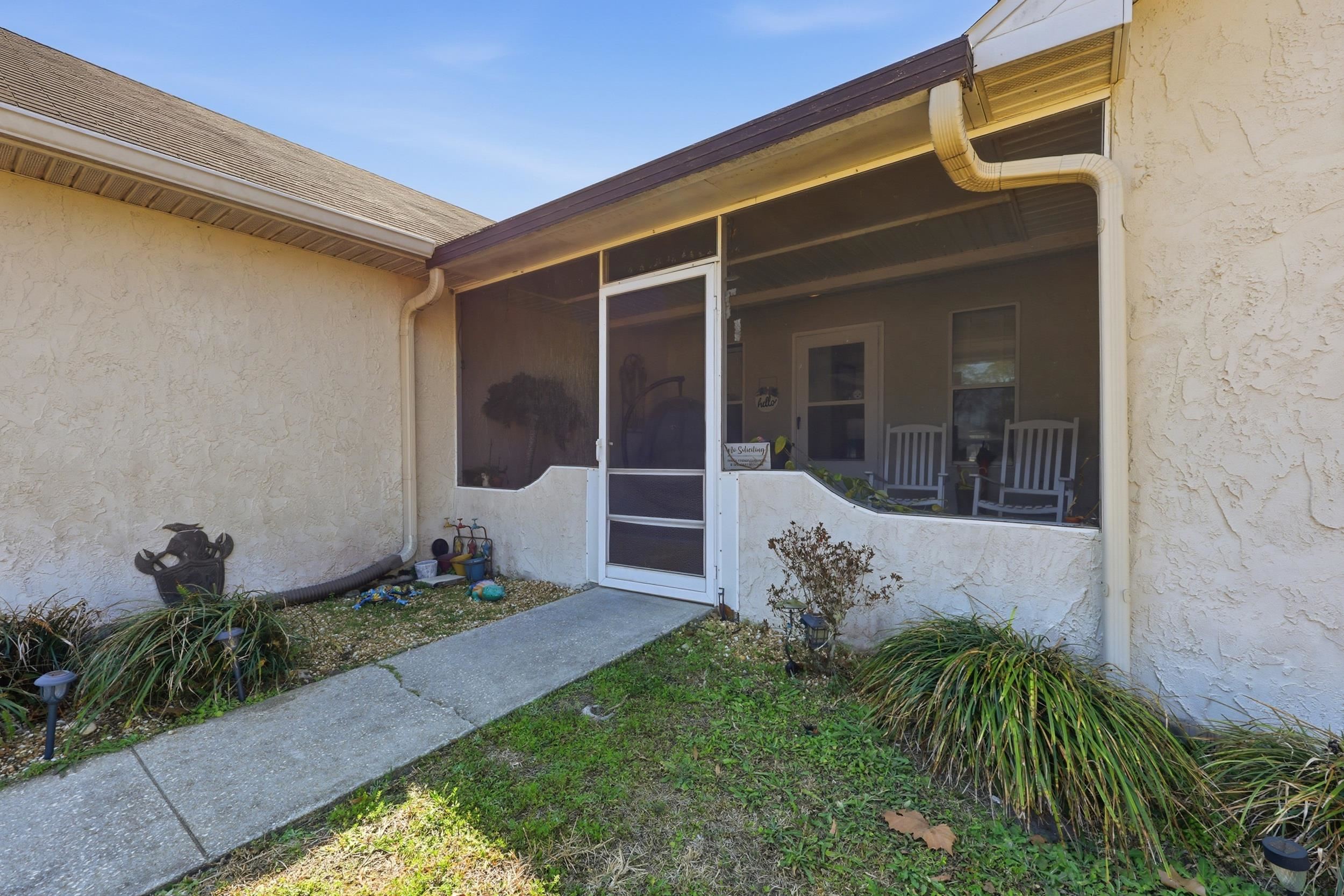 5296 Timucua Circle St. Augustine, FL 32086 - Photo 5 of 65 Entrance to property featuring a sunroom and stucco siding
