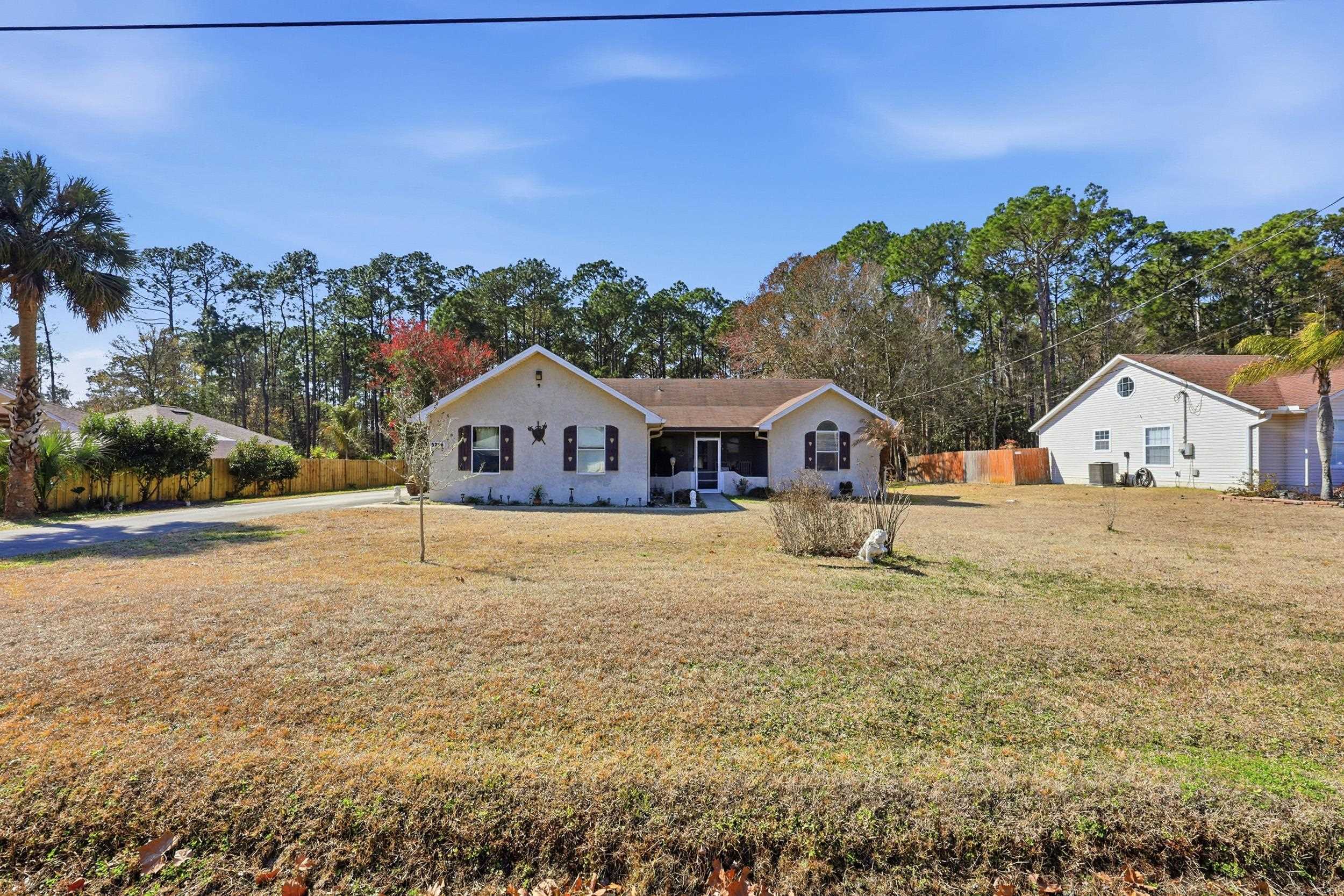 5296 Timucua Circle St. Augustine, FL 32086 - Photo 52 of 65 View of front of home with a porch and view of wooded area