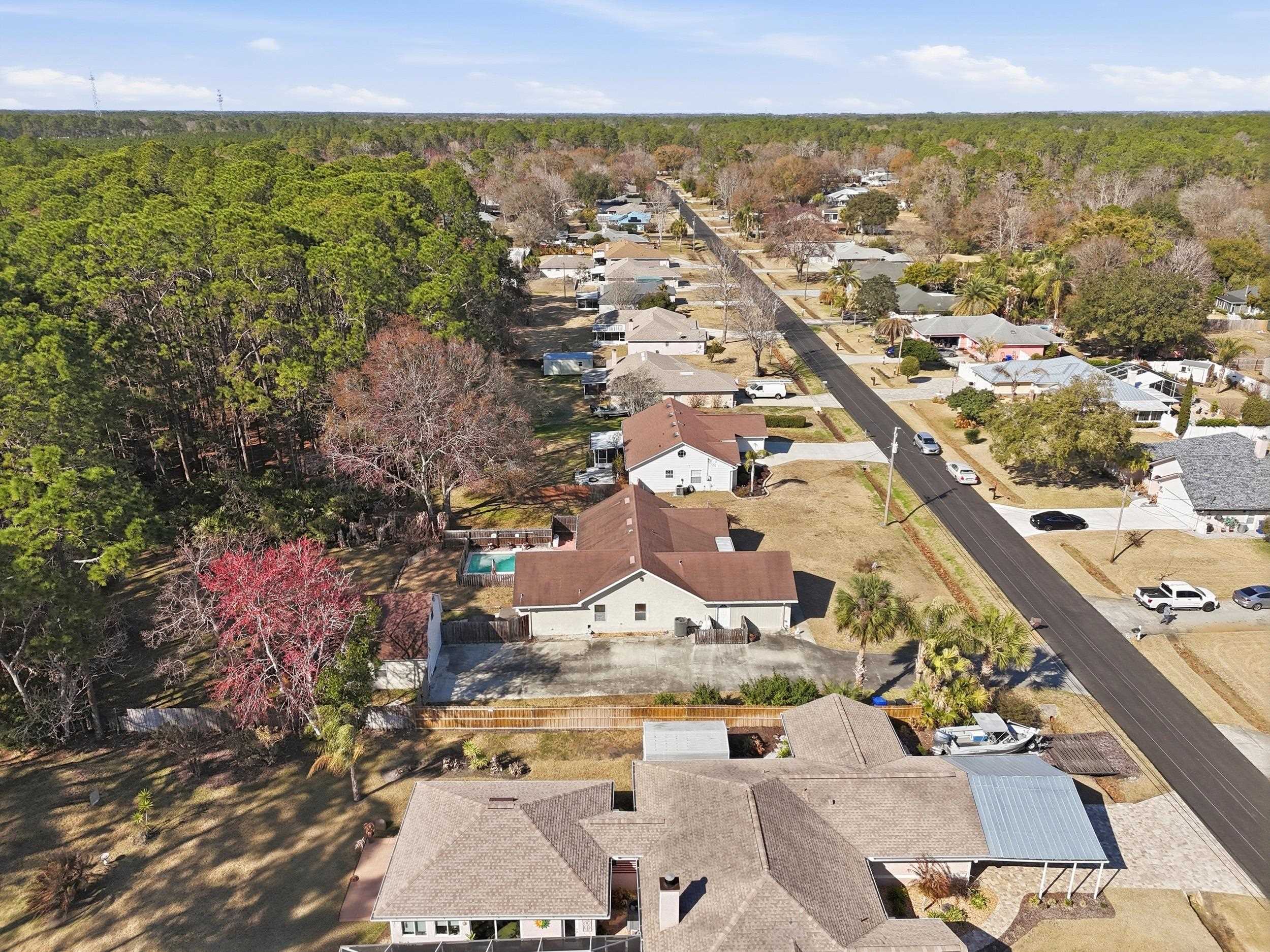 5296 Timucua Circle St. Augustine, FL 32086 - Photo 56 of 65 Aerial view of property and surrounding area featuring nearby suburban area and a forest