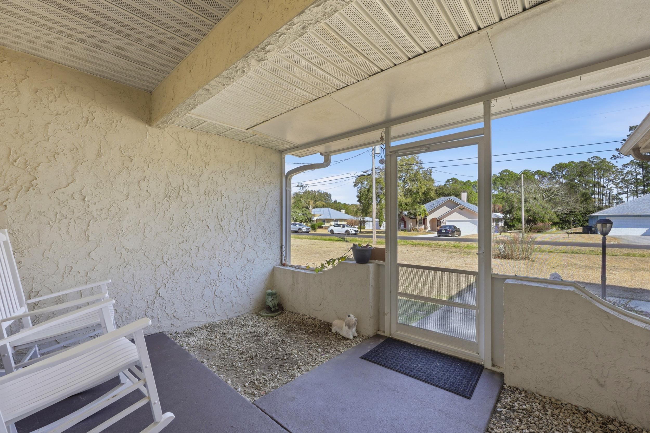 5296 Timucua Circle St. Augustine, FL 32086 - Photo 7 of 65 Sunroom featuring a residential view